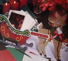 a christmas card with a reindeer pulling a sleigh filled with gifts on it