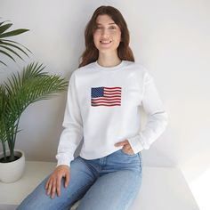 This American Flag sweatshirt exudes patriotism and coziness, making it perfect for chilly months. The medium-heavy fabric blend of 50% cotton and 50% polyester provides warmth, while the classic fit and crew neckline ensure a comfortable and stylish wear. Ideal for those who love showing their national pride, this sweatshirt is perfect for Fourth of July celebrations and everyday casual wear. Product features - Medium-heavy fabric blend of 50% cotton and 50% polyester for coziness - Classic fit Patriotic White Cotton Sweatshirt, Patriotic Long Sleeve T-shirt With American Flag Print, Patriotic Cotton Sweatshirt With American Flag Print, White Long Sleeve T-shirt With American Flag Print, Patriotic Graphic Print Sweatshirt, Patriotic Long Sleeve Sweatshirt With Graphic Print, Casual White Sweatshirt With American Flag Print, Cotton Crew Neck Sweatshirt With Flag Print, Patriotic Long Sleeve Cotton Sweatshirt