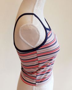 Sweet vintage Champion sports crop top. Colorful stripes,blue suspenders and a edge around the sleeve. It has a logo printed at the end. Fabric is stretchy. It is padded on the chest,see last image. In excellent vintage condition. Tag size: US M,but smaller,best fits to size US XS/S,check the measures. Materials: polyester 88%,spandex 12% Label: Champion  Measures taken flat,one side bust 36.5 - 48 cm = 14,37 - 18,90" waist 34 - 37 cm = 13,38 - 14,57" length with suspenders about 43 cm = 16,93" We will take returns only if there is a problem with condition we did not detected. Please,check the measures before purchasing. All items are vintage in excellent condition with respect to the years. Please write me a message when the package arrives and are you satisfied. Thank you for purchasing Striped Fitted Sportswear Top, Spring Striped Sports Tops, Fitted Striped Tops For Sports, Fitted Tank Top With Contrast Stripes For Spring, Sporty Striped Tank Top For Summer, Fitted Sleeveless Top With Contrast Stripes, Striped Fitted Tank Top With Tank Straps, Fitted Striped Tank Top, Sporty Fitted Top With Straps