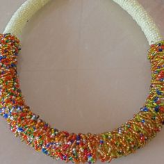 a beaded necklace is displayed on a table