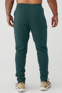 Layer it to and from the studio, practice in it or lounge in it: the Triumph Sweatpant is made of insanely comfortable triblend fleece. An easy-fitting drop crotch, wide gusset panel and drawcord waist are finished with fitted rib panels on the calves and inseam. For working out and wearing out Adjustable drawcord waistband Invisible zip pockets Ribbed Paneling, Midnight Green, Men's Activewear, Street Smart, Smart Trousers, Invisible Zip, Yoga For Men, Back Women, Mens Activewear