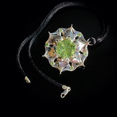 This handcrafted one-of-a-kind pendant features a green glass collector's gem cut by the renowned lapidary artist Dalan Hargrave based in Texas.  The green glass gem is accented by natural tsavorite garnets. It is made from solid 925 sterling silver. I paired this pendant with a black velvet choker with sterling silver clasps, comfortable for daily wear or special occasions. Black Velvet Choker, Tsavorite Garnet, Velvet Choker, Glass Gems, Sterling Silver Flowers, Flower Pendant, Green Glass, Sterling Silber, Solid 925 Sterling Silver