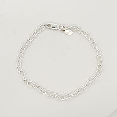 This Silver Charm Bracelet is a stylish and versatile accessory for women. Made of high-quality .925 sterling silver, this bracelet adds a touch of elegance to any outfit. With its simple yet eye-catching design, it is perfect for everyday wear or special occasions. Enhance your style with this must-have piece. The bracelet is 7" long, and charms are sold separately. Classic Silver Chain Bracelet For Everyday, Classic Silver Charm Bracelet For Everyday, Classic Adjustable Silver Chain Charm Bracelet, Classic Charm Bracelet With Lobster Clasp For Everyday, Everyday Silver Chain Bangle Bracelet, Modern Silver Charm Bracelet For Everyday, Everyday Bangle Charm Bracelet With Extender, Classic Charm Bracelet With Sterling Silver Clasp, Sterling Silver Bracelet With Silver Chain For Everyday Wear