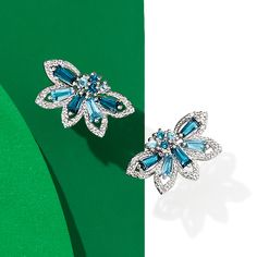 Ross-Simons - .96ct t. w. Tonal Blue Topaz, .10ct t. w. Diamond Earrings in Silver. This wintry pair will add a touch of cool elegance to your ensemble. Round and tapered baguettes of London and Swiss blue topaz totaling .96 carats are sparked by .10 ct. t. w. diamonds in a floral design set in sterling silver. Hanging length is 3/8". Post/clutch, diamond and tonal blue topaz earrings. Blue Topaz birthstones are the perfect gift for December birthdays. Fine Jewelry Blue Cluster Earrings, Blue Cluster Earrings In Fine Jewelry Style, Blue Cluster Earrings Fine Jewelry, Blue Cluster Earrings For Anniversary, Blue Cubic Zirconia Earrings With Gemstone Accents, Blue Earrings With Cubic Zirconia Gemstone Accents, Topaz Birthstone, December Birthday, Blue Topaz Earrings