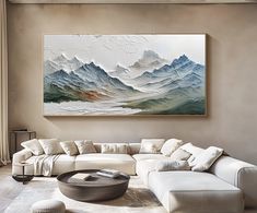 a living room filled with furniture and a large painting on the wall above it's couch