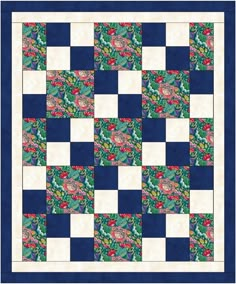 a blue and white quilt that has flowers on it, with green leaves in the center