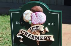 a sign for an ice creamery with two scoops of ice cream on it