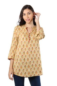 Printed onto the beige body of this rayon tunic lovely flowers are resplendent. Indian artisan Isha Jain designs this feminine tunic featuring three-quarter-length sleeves and a button-up henley neckline. Spring Floral Print Straight Kurta Blouse, Floral Print Straight Kurta Blouse For Spring, Festive Floral Print Tunic, Spring Beige Kurta With Printed Motifs, Beige Kurta With Printed Motifs For Spring, Spring Floral Print Kurta With 3/4 Sleeves, Summer Beige Kurta With Printed Motifs, Bohemian Beige Kurta With Printed Motifs, Floral Print 3/4 Sleeve Kurta For Spring