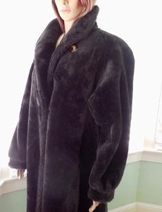 This is a Gorgeous Faux Fur Coat. It is a thick plush faux fur coat with a tortoise shell button at the neck and 3 furrier hooks down the front. This coat is dark brown with padded drop shoulders and slide in pockets. The inside is fully lined in a dark brown sateen material. This oversized coat shows no signs of wear and is in Excellent Condition! Label:    AMERICAN SIGNATURE Made In USA  Size:      MEDIUM to LARGE Tag reads Medium (Double Check Measurements) Measurements are taken with the gar Winter Coat Elegant, Luxury Coat, Vintage Faux Fur Coat, Coat Elegant, Full Length Coat, Plush Coat, Derby Dress, Super Dark, Long Winter Coats