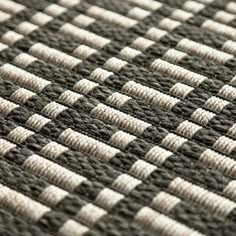 close up view of woven material with white and black squares on it's surface