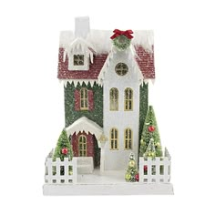 a white christmas house with red roof and windows