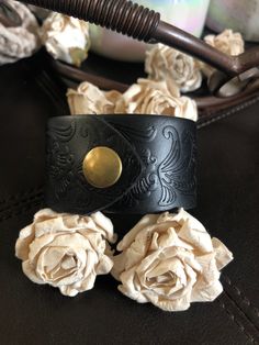 "🔸🔸orders are delayed by a few days this week. Thank you for your patience Fleur de lis bracelet leather cuff Embossed black new 1 1/2\" genuine leather strap has been adorned with an antiqued silver Fleur de lis concho which sets on top of a detailed antiqued bronze filigree which as been riveted to the leather with two textured antiqued bronze rivets. One antiqued bronze snap has been added to fit up to a 7\" wrist. I can add another snap for a larger or smaller wrist but you need to convo m Unique Black Leather Jewelry, Formal Leather Cuff Jewelry, Vintage Leather Strap Cuff Bracelet Gift, Unique Hand Tooled Black Jewelry, Unique Leather Cuff Jewelry, Vintage Hand-tooled Leather Bracelet Gift, Vintage Hand Tooled Leather Bracelet Gift, Vintage Hand-tooled Cuff Bracelet As Gift, Vintage Hand Tooled Cuff Bracelet As Gift