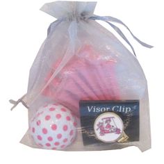 two pink and white golf balls in a bag