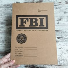 a person holding a brown paper with the words fbfi on it