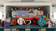 a stage set up for a sports event with balls and other items on the stage