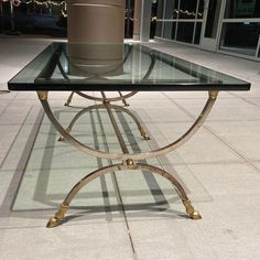 a glass table with a potted plant on top