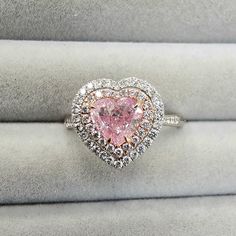 a pink heart shaped diamond ring on display