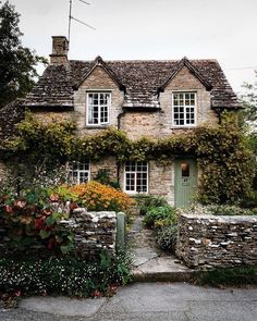 an old stone house with ivy growing on it