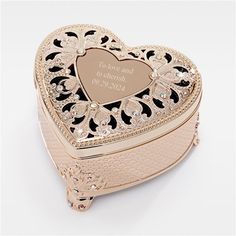 a gold heart shaped box with an inscription on it