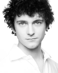 a black and white photo of a man with curly hair