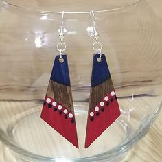 the earrings are made out of wood and have red, white, and blue shapes