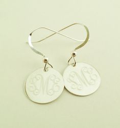 "Dangle Earrings in Sterling Silver Perfect present for Valentines Day or any occasion. Sterling silver dangle earrings will be monogrammed engraved permanently. Top quality 925 sterling silver. Comes gift boxed. Please state engraving information in notes to seller at checkout. Shown with Interlocking monogram, single initials also look very good on these. You can see font choices in extra photos. For Monograms please provide initials in first, last, middle order. Earrings- 1/2\" Sterling Silve Classic Engraved Silver Earrings, Classic Engraved Sterling Silver Earrings, Sterling Silver Monogram Round Disc Jewelry, Personalized Minimalist Dangle Earrings, Engraved Sterling Silver Earrings, Engraved Sterling Silver Round Earrings, Personalized Drop Earrings For Anniversary, Round Engraved Sterling Silver Earrings, Dainty Initials Earrings Perfect For Gifts