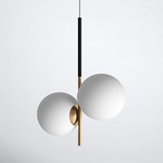 two white balls hanging from a brass colored light fixture