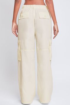 Every day is a new chance to wear our Women’s Relaxed Fit Cargo Pants. This high-waisted nylon pant features a relaxed fit for both style and comfort, ensuring you’ll look good and feel good throughout the day. Includes classic front pockets, three cargo pockets with button closures, and faux back pockets for maintaining a smoothing effect on your bum. These trendy pants are detailed with metal d-rings on the front belt loops and a drawstring waist so you can adjust the fit to your liking. Style Spring Cargo Style Wide-leg Bottoms, Spring Wide-leg Cargo Style Bottoms, Spring Wide-leg Bottoms In Cargo Style, Spring Utility Full Length Parachute Pants, Versatile Summer Parachute Pants With Pockets, Versatile Parachute Pants With Pockets For Summer, Utility Wide Leg Nylon Bottoms, Relaxed Fit Wide Leg Nylon Parachute Pants, Baggy Wide Leg Nylon Bottoms