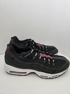 Elevate your sneaker game with these Nike Air Max 95 Essential fashion sneakers. With a sleek anthracite and black design accented with team red, these shoes are perfect for any stylish man. The shoes boast a size 13 US and 12 UK shoe size, making them suitable for a range of foot sizes. They are part of the Nike Air product line and feature the model number DQ3982-001, ensuring you are getting an authentic and quality product. These shoes are perfect for anyone looking to add some style to their wardrobe. The Nike Air Max 95 Essential sneakers are perfect for daily wear, whether you're out for a run or just running errands. The shoes are brand new and come without a box, making them a hassle-free purchase. Add these sneakers to your collection today and step up your fashion game. Casual Black Nike Air Max For Light Sports, Black Synthetic Nike Air Max For Jogging, Nike Air Max Lace-up Synthetic For Jogging, Functional Nike Air Max Lace-up Sneakers, Sporty Black High-top Nike Air Max, Black High-top Nike Air Max Sneakers, Nike Air Max Gray Sneakers For Sports, Casual Gray Low-top Nike Air Max, Black Nike Air Max Lace-up For Jogging