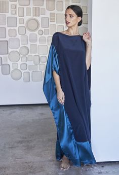 Eco friendly caftans and tunics inspired by the ocean, made on main street. Ethically sourced and locally made in Los Angeles. We love a good color block story.  When it works, it REALLY works, and this rich teal and navy combo is as luxe as it gets.  Perfect in our simple-but-elegant adjustable boatneck silhouette, this caftan can be worn two ways:  as a traditional boat neck, or, off the shoulder.  Two clasps on either side of the neckline allow you to change the look with one quick move.  Keep the clasps closed for a demure, flattering, bra-friendly neckline, or, release one or both clasps for a full-drama, one or two shoulder look.  Either way, this one is as elegant as it gets.    Sheerness: none Model height: 5'9" Length: 50" Fabric: 100% Silk CDC and Charmeuse What is Silk CDC and C Silk Caftan, Kaftan Designs, Long Kaftan, Mode Abaya, Silk Kaftan, Gauze Dress, فستان سهرة, Caftan Dress, By The Ocean