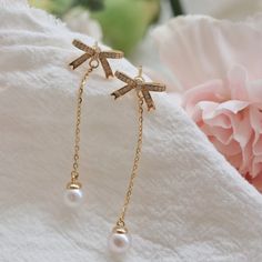 These long tassel earrings exude an unparalleled elegance and sophistication. At the top, a gracefully designed bow adorns the earrings, embellished with sparkling small zircons that twinkle like stars in the night sky. Dangling gracefully from the bottom is a single, natural high-quality pearl, emitting a soft and enchanting glow. The metal accents come in two elegant color options: gold and silver. Both are crafted from high-quality S925 silver, ensuring durability and luxuriousness. The gold Elegant Silver Tassel Earrings For Gift, Elegant Pearl Drop Tassel Earrings, Elegant Pearl Drop Dangle Tassel Earrings, Dangle Tassel Earrings With Pearl Drop For Gifts, Elegant Dangle Linear Earrings As Gift, Silver Elegant Tassel Drop Earrings, Silver Tassel Single Earring As Gift, Silver Tassel Earrings For Gifts, Elegant Silver Tassel Drop Earrings