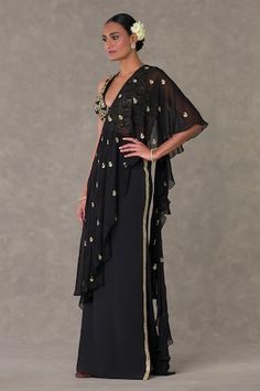 Black saree gown featuring an attached ruffle pallu and intricate paan phool motifs, Fit: Relaxed Traditional Drape Dress With Sheer Dupatta For Gala, Chic Dresses With Traditional Drape For Festive Occasions, Formal Dress With Sheer Dupatta And Cape Sleeves, Elegant Georgette Pre-draped Maxi Saree, Elegant Pre-draped Maxi Length Georgette Saree, Evening Gown With Sheer Dupatta, Festive Pre-draped Evening Gown, Black Cape Sleeve Festive Dresses, Elegant Georgette Maxi Dress With Traditional Drape