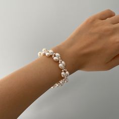 The Handmade Twist Oval Pearls Bracelet is a unique and stunning piece of jewelry that matches well with any bridal dress or other daily outfit. Made by skilled artisans, this bracelet features a twist design that adds a touch of elegance to the smooth and lustrous oval-shaped pearls. The pearls are hand-selected for their quality and color, ensuring that each bracelet is one-of-a-kind. Pearl Type: Freshwater Pearls Pearl Quality: [Shape]: Oval Shape [Pearl Size]: 6-7mm [Blemish]: Minor [Luster] Elegant Adjustable Bracelets For Anniversary, Elegant Oval Bracelets For Party, Elegant White Crystal Bracelet For Anniversary, Elegant Crystal Bangle Bracelet, Elegant Pearl White Bracelet For Party, Elegant Pearl White Bracelets For Party, Elegant White Crystal Bracelet For Formal Occasions, Elegant Handmade Crystal Bracelet For Party, Handmade Elegant Crystal Bracelet For Party