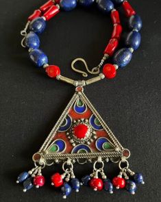 Artisan Red Jewelry With Inlay, Artisan Red Jewelry With Large Pendant, Artisan Red Inlay Jewelry, Traditional Red Coral Jewelry With Polished Beads, Traditional Red Coral Round Bead Jewelry, Artisan Red Ceremonial Necklaces, Artisan Red Ceremonial Necklace, Artisan Red Necklaces For Ceremonial Use, Traditional Red Gemstone Necklaces