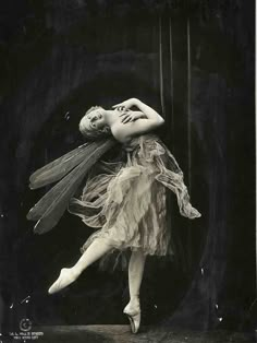 an old photo of a ballerina in the air