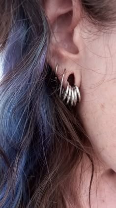 a close up of a person's ear wearing earrings