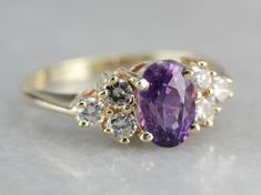 "Beautiful, classic and timeless, this vintage ring is the perfect setting for the pretty, blackberry hued sapphire we've set at the center. Purchased on one of our frequent buying trips to Sri Lanka, or old Ceylon, this purple sapphire has outstanding flash and glitter, perfectly balanced by the tapered diamond shoulders. Metal: 14K Yellow Gold Gem: Purple Sapphire 1.43 Carats Gem Measurements: 5.2 x 7.8 mm, Oval Accents: 6 Diamonds totaling .36 Carats, H in Color, SI in Clarity Ring Size: 7 Ma Yellow Gold Sapphire Ring, Crystal Goddess, Ring Sapphire, Sapphire And Diamond Ring, Purple Sapphire, Cameo Ring, Sapphire Engagement Ring, July Birthstone, Sapphire Engagement