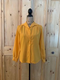 "1 mustard color  6 button front closure  Button cuff Collar  100% polyester  Chart size 8/medium  1 Rust color  Pullover  Collar  100% nylon  Chart size 10/medium  Sleeve and blouse length 23\" for both blouses  Both are in excellent vintage condition" Cheap Yellow Vintage Blouse, Mustard Long Sleeve Blouse For Fall, Classic Long Sleeve Yellow Blouse, Classic Yellow Long Sleeve Blouse, Formal Yellow Long Sleeve Blouse, Yellow Fall Blouse For Daywear, Yellow Fall Daywear Blouse, Yellow Workwear Tops With Button Cuffs, Retro Mustard Long Sleeve Tops