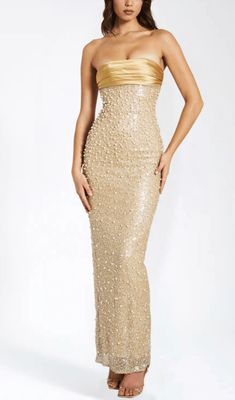 This stunning gold satin maxi dress is adorned with intricate sequins and delicate pearls, creating a truly luxurious and exclusive piece. Its flowing silhouette and exquisite detailing make it the perfect choice for any glamorous occasion. Elevate your wardrobe with this opulent dress. Materials: Sequin & Pearl Be Long Hoco Dresses Tight, Gold Formal Dresses Long, Gold Beaded Bridesmaid Dresses, Long Pearl Dress, Gold Sequin Maxi Dress, Pearl Maxi Dress, Luxury Dress Glamour, Gold Dresses Formal, Gold Formal Dresses