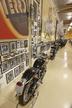 motorcycles are lined up against the wall with pictures on it