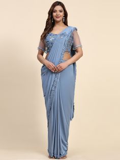 Stitched Saree with blouse in Powder blue colour 102073A A full-stitch drape saree is a contemporary take on the traditional Indian saree, combining the elegance of the drape with the convenience of a pre-stitched garment. This innovative design features a pre-pleated pallu and a stitched skirt, offering ease of wear without compromising on style. Ideal for modern women who appreciate the grace of a saree but seek practicality in their attire, the full-stitch drape saree allows for effortless dr Festive Blue Pre-draped Saree For Evening, Blue Draped Blouse Piece For Evening, Blue Draped Lehenga For Reception, Blue Georgette Pre-draped Saree With Self Design, Draped Georgette Saree With Unstitched Blouse, Eid Special Zari Work Pre-draped Saree, Elegant Blue Pre-draped Saree, Eid Unstitched Draped Blouse Piece, Unstitched Draped Blouse Piece For Eid