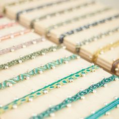 many bracelets are lined up on a table