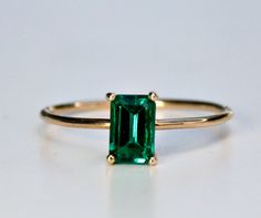 "This beautiful Emerald Gold Ring was handmade in Melt'm Jewelry Design Studio in California using 14k solid yellow gold band and 6x4mm emerald cut lab grown emerald stone. Emerald is featuring in 14k gold prong setting. DETAILS ABOUT THE RING, MATERIAL AND STONES Ring Band: 14K solid gold Ring Band size: 1 mm thick Gemstone: Lab grown Emerald Emerald size: 6mm x 4mm emerald cut Yellow gold or white gold options available from drop down menu. On the video shown 3 diamonds curved wedding band als Emerald Cut Gemstone Stackable Rings In 14k Gold, Emerald Cut Solitaire Stackable Rings In 14k Gold, Classic Green 14k Gold Stackable Rings, 14k Gold Stackable Emerald-cut Rings For May Birthstone, 14k Gold Emerald-cut Stackable Rings For May Birthstone, Minimalist 14k Gold Emerald Ring With Prong Setting, Classic Stackable 14k Gold Gemstone Rings, Minimalist 14k Gold Emerald-cut Birthstone Ring, Minimalist 14k Gold Emerald Cut Birthstone Ring