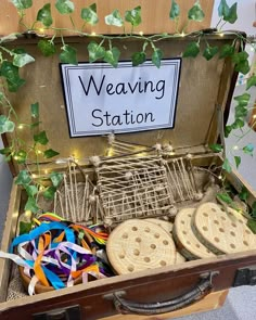 an open suitcase filled with lots of different types of ribbons and decorations on top of it