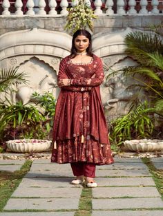 This Set Has a Anarkali, bottom and dupatta. Floral printed Anarkali set with gotta Patti handwork on neck and sleeves paired with matching chanderi foil print dupatta enhanced with fabric detailing and palazzo pants. Color: Brown Fabric: Anarkali - Cotton Silk Bottom - Shantoon Dupatta - Chanderi Product Details: Neck Type - Round neck Anarkali Length - 50 inches Bottom Length - 38-40 inches Sleeve Length - 22 inches Note: Available in other colors The product will be delivered within 2-4 weeks Unstitched Anarkali Set In Traditional Drape, Unstitched Bollywood Anarkali Set With Traditional Drape, Unstitched Chanderi Bollywood Anarkali Set, Unstitched Bollywood Chanderi Anarkali Set, Unstitched Anarkali Set With Dupatta, Anarkali Set With Cutdana On Jamawar Fabric, Bollywood Style Semi-stitched Slub Silk Palazzo Set, Diwali Jamawar Anarkali Set, Anarkali Slub Silk Set With Pallu