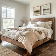 a large bed sitting in a bedroom on top of a hard wood floored floor