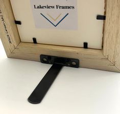 a wooden frame with a black handle on the bottom and label that says lakeview frames