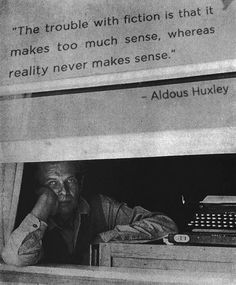 a man sitting at a desk in front of an old typewriter