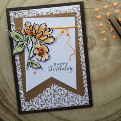 a happy birthday card with flowers on it and some scissors next to the card that says happy birthday