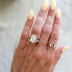 a woman's hand with two rings on it and a ring in the middle